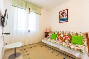 a living room with a couch and a window at Apartments Racchi in Banjole