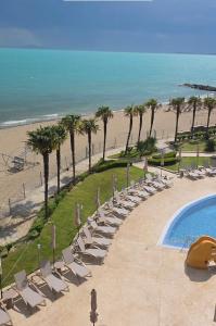 a group of chairs and a swimming pool next to a beach at Sandy Bay Resort - All Inclusive Private Beach Hotel in Sveti Vlas +75 photos