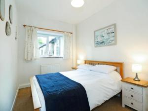 a bedroom with a white bed and a window at Harvest - Ukc9523 in Barnstaple