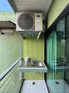 a bathroom with a sink and a fan on a balcony at Peaberry Place - พีเบอร์รี่เพลส in Ban Zong Katiam +27 photos