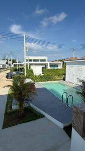 a swimming pool in front of a house at Pool Villa Maephim 34, by Somjai in Ban Tha Fat