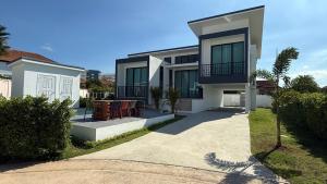 a large house with a driveway in front of it at Pool Villa Maephim 34, by Somjai in Ban Tha Fat