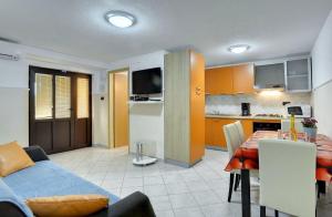 a living room and kitchen with a blue couch and a table at Villa Semy in Pazin