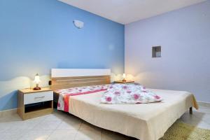 a bedroom with a bed and two night stands with lamps at Villa Semy in Pazin +25 photos