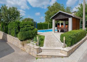 a garden with a gazebo next to a pool at Villa Semy in Pazin