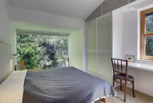 a bedroom with a bed and a chair and a window at Villa Mala Villa in Krnica +32 photos