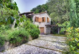 an old stone house with a stone driveway at Villa Mala Villa in Krnica