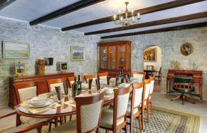 a dining room with a long table and chairs at Villa Lucy in Barban