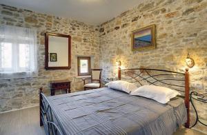a bedroom with a bed and a stone wall at Villa Lucy in Barban +31 photos