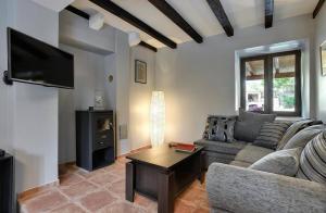 a living room with a couch and a table at Villa BR in Ližnjan
