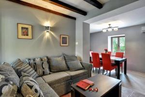 a living room with a couch and a table at Villa BR in Ližnjan