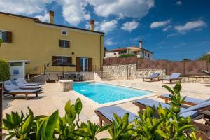 a swimming pool in front of a house at House Casa Alberta in Rovinjsko Selo