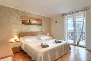 a bedroom with a bed with two towels on it at House Casa Alberta in Rovinjsko Selo +45 photos