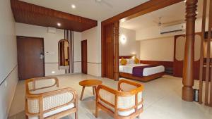 a hotel room with a bed and a table and chairs at Bliss Giriya By Bergamont in Tiruvannāmalai +280 photos