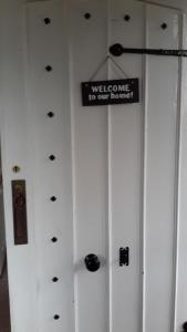 a sign that says welcome to our room on a wall at The School House in Warrington