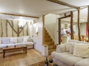 a living room with two couches and a staircase at Lavender Cottage - Ukc9687 in Thorndon