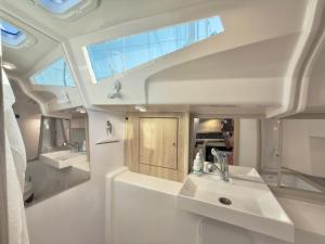 a bathroom with two sinks and a mirror at Hausboot Segelyacht Nui in Burgtiefe auf Fehmarn  +22 photos