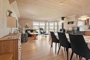 a kitchen and living room with a table and chairs at FY130-Middelfart-Stjernevej-117 in Middelfart