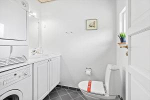 a white bathroom with a toilet and a sink at FY130-Middelfart-Stjernevej-117 in Middelfart +14 photos