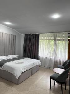 a bedroom with a bed and a table and a chair at Ararat hotel in Goris +16 photos