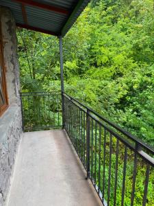 a balcony with a black railing and trees at Ararat hotel in Goris