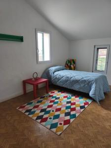 a bedroom with a bed and a rug on the floor at Civico 18 in Caposotto