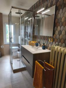 a bathroom with a sink and a toilet and a mirror at Civico 18 in Caposotto