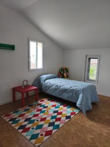 a bedroom with a bed and a rug at Civico 18 in Caposotto +23 photos