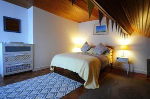 a bedroom with a bed and a television in it at La Maison Rose in Mhère