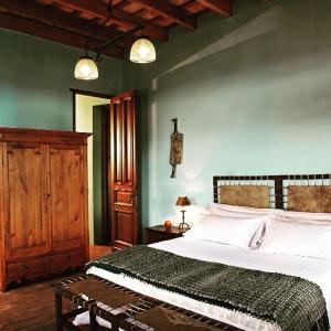 a bedroom with a large bed and a wooden cabinet at La Negrita Casa de Campo in Azcuénaga +42 photos