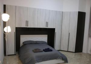 ein Schlafzimmer mit einem großen Bett und weißen Schränken in der Unterkunft Melzo INN in Melzo