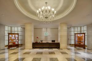 a large lobby with a chandelier and a desk at Sunrise On The Bund in Shanghai +43 photos