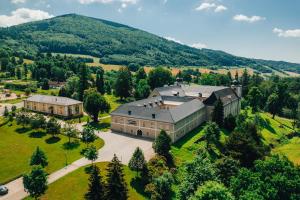 an aerial view of a large house in the mountains at Apartmán NIC VÍC in Loučná nad Desnou
