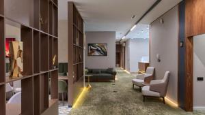a hospital corridor with chairs and a waiting room at City Line HOTEL in Astana