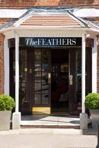 a front door of a building with the eaters sign at The Feathers Hotel in Woodstock