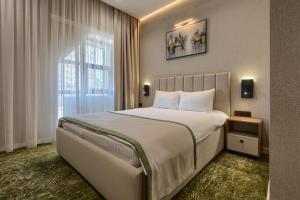a bedroom with a large bed and a window at City Line HOTEL in Astana +122 photos
