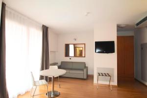 a living room with a couch and a table at Hotel Rubicone in Savignano sul Rubicone +26 photos