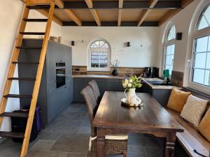 a kitchen and dining room with a wooden table at Alte Schmiede in Sundern