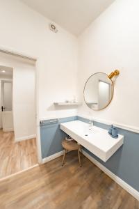 a bathroom with a white sink and a mirror at Inderooms Carloforte in Carloforte +24 photos