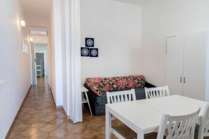 a living room with a couch and a table at Appartamento Sunny by ThePuglia in Torre Lapillo
