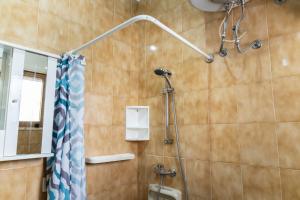 a bathroom with a shower with a shower curtain at Appartamento Sunny by ThePuglia in Torre Lapillo +8 photos