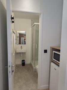 a bathroom with a shower and a toilet and a sink at Kyriad ECO - Tours Nord in Tours +6 photos