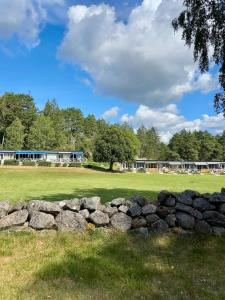 a pile of rocks in front of a field at Hällestrand Semesterby R19 in Strömstad