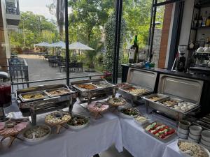 a buffet table with many trays of food on it at Ritsa Resort in Ureki