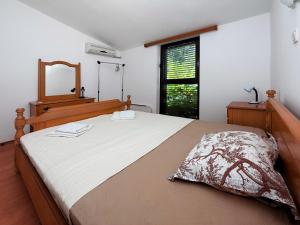 a bedroom with a large bed and a mirror at Villa Four-bedroom Prcan Kotor in Prčanj