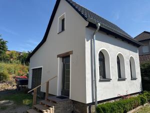 a small white church with windows and stairs at Alte Schmiede in Sundern