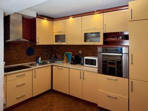 a small kitchen with white cabinets and appliances at Villa Four-bedroom Prcan Kotor in Prčanj +30 photos