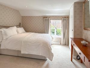 a bedroom with a bed and a window at Militia Cottage in Marlborough