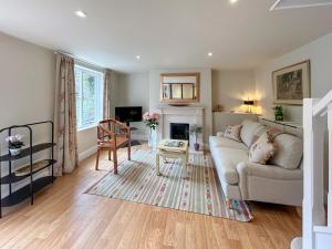 a living room with a couch and a table at Militia Cottage in Marlborough