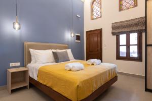 a bedroom with a bed with towels on it at Jivaeri Luxury Suites in Rhodes Town